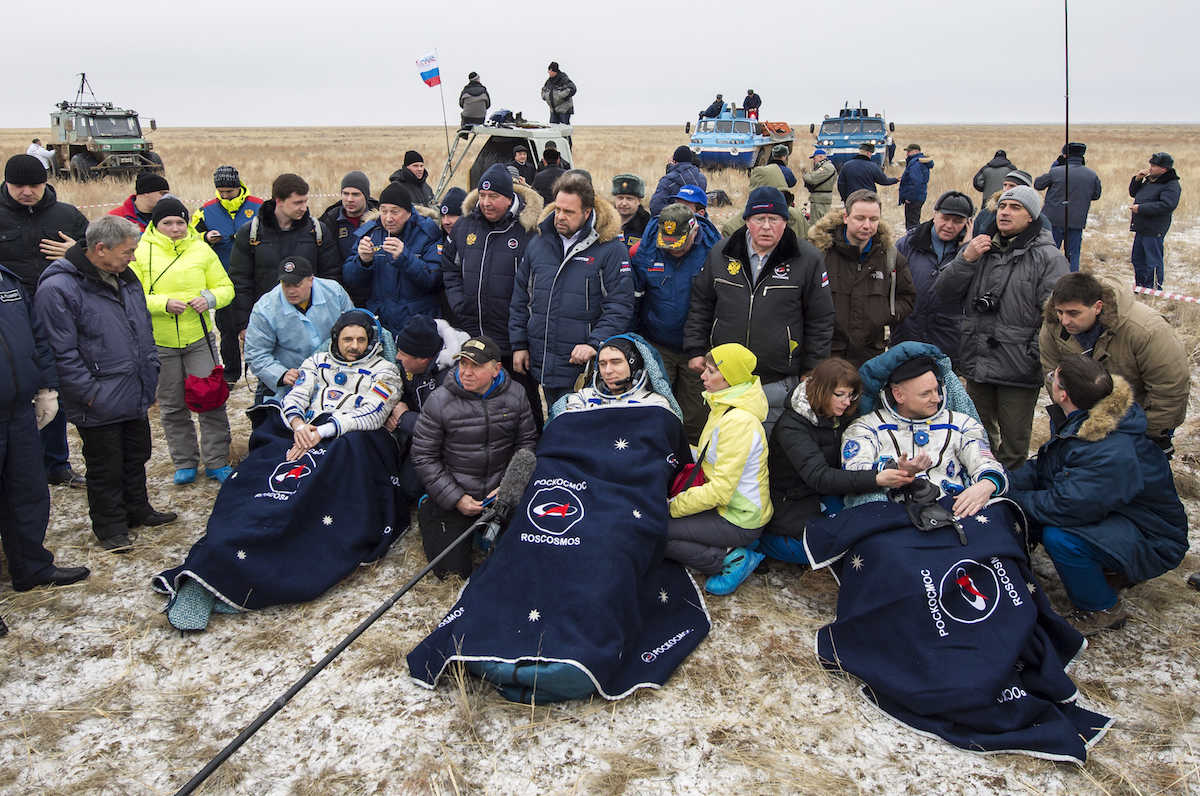 Russian cosmonauts Mikhail Kornienko, left, Sergey Volkov, center, and U.S. astronaut Scott Kelly rest in chairs outside the Soyuz TMA-18M space capsule after they landed in a remote area outside the town of Dzhezkazgan, Kazakhstan, on Wednesday, March 2, 2016. Kelly and Kornienko are completing an International Space Station record year-long mission to collect valuable data on the effect of long duration weightlessness on the human body that will be used to formulate a human mission to Mars. Volkov is returning after six months on the station.  (Bill Ingalls/NASA via AP)