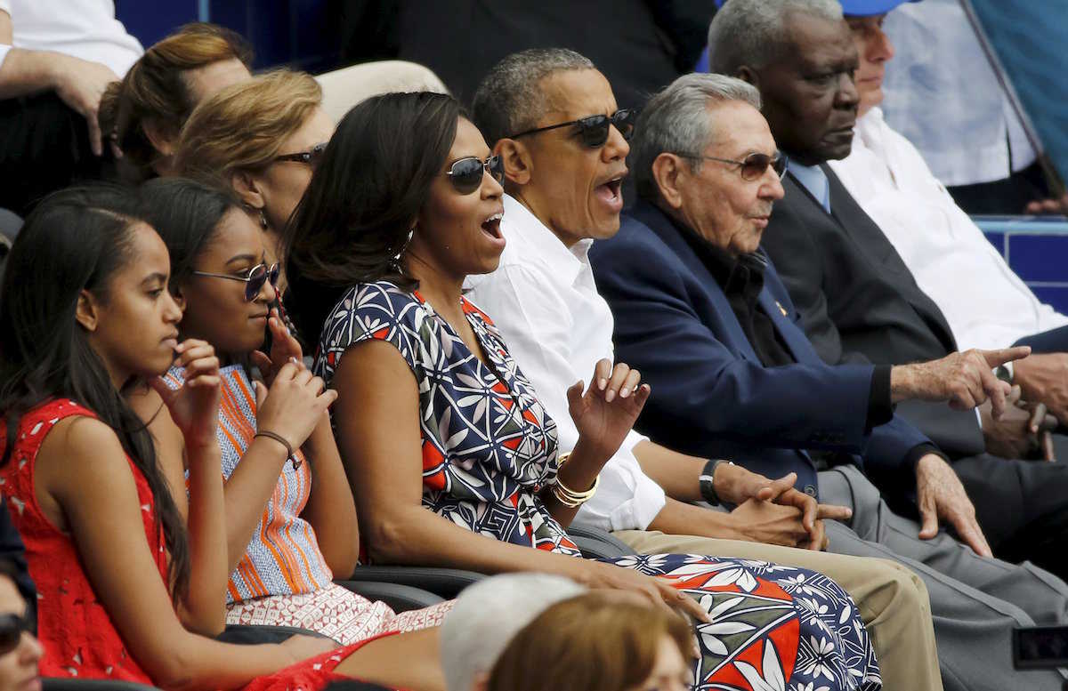 U.S. President Barack Obama and his family react along with Cuban President Raul Castro to an exhibition baseball game between the Cuban National team and the MLB Tampa Bay Rays at Estadio Latinoamericano in Havana March 22, 2016. REUTERS/Jonathan Ernst TPX IMAGES OF THE DAY